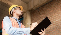 <p>Engineer or inspector checking progressing work in construction site</p>